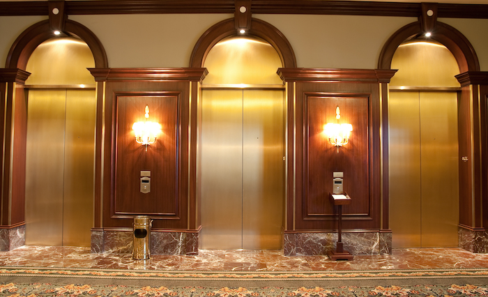 three elevator cabs with common elevator cab finishes