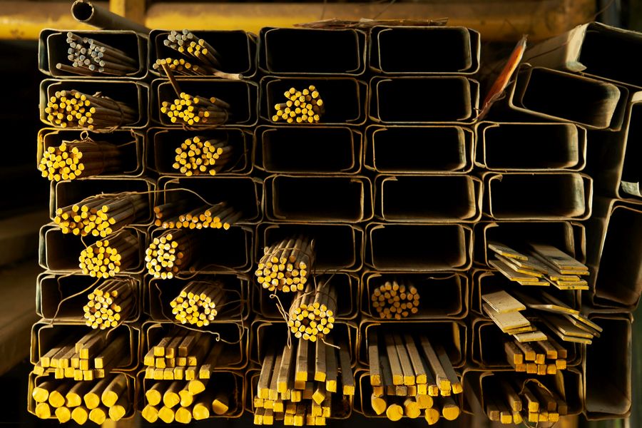 a collection of brass metal bars including flat, square, and round