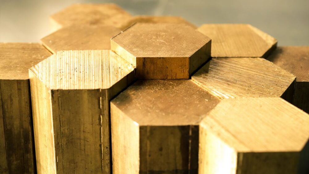 closeup of yellow brass hexagonal metal rods