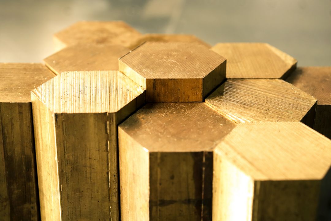 closeup of yellow brass hexagonal metal rods